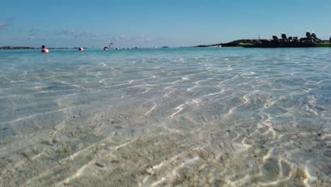 Low-angle-view-of-sea-at-shore-with-clear-water-and-white-sand-underwater