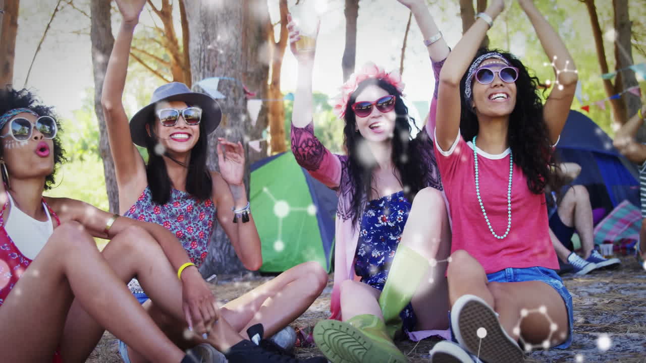Celebrating outdoors, group of friends sitting together under sunlight, feeling happy