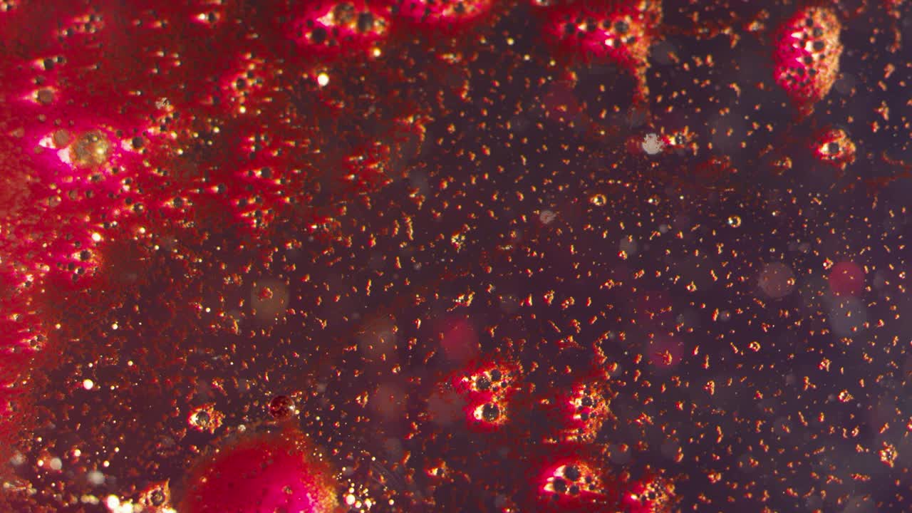 Expanding galaxy splash blood red splatter texture bokeh background