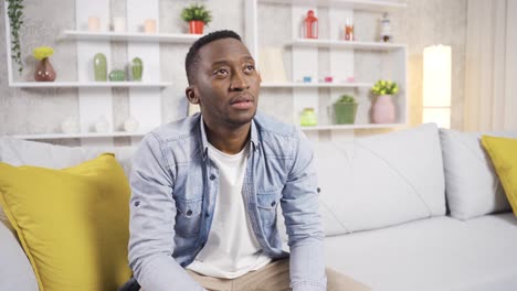 Stressed-and-depressed-african-man-thinking-alone-at-home.