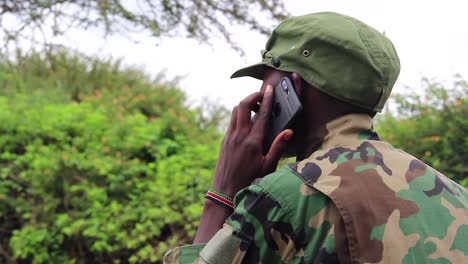 african guerilla militant soldier talking on cellphone