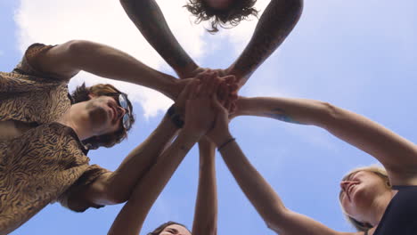 circle of friends holding hands.