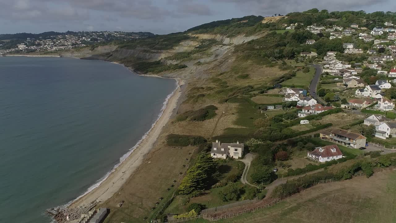 Aerial view of a coastal town with beach and cliffs