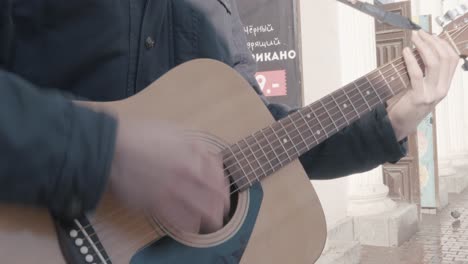 street musician playing acoustic guitar