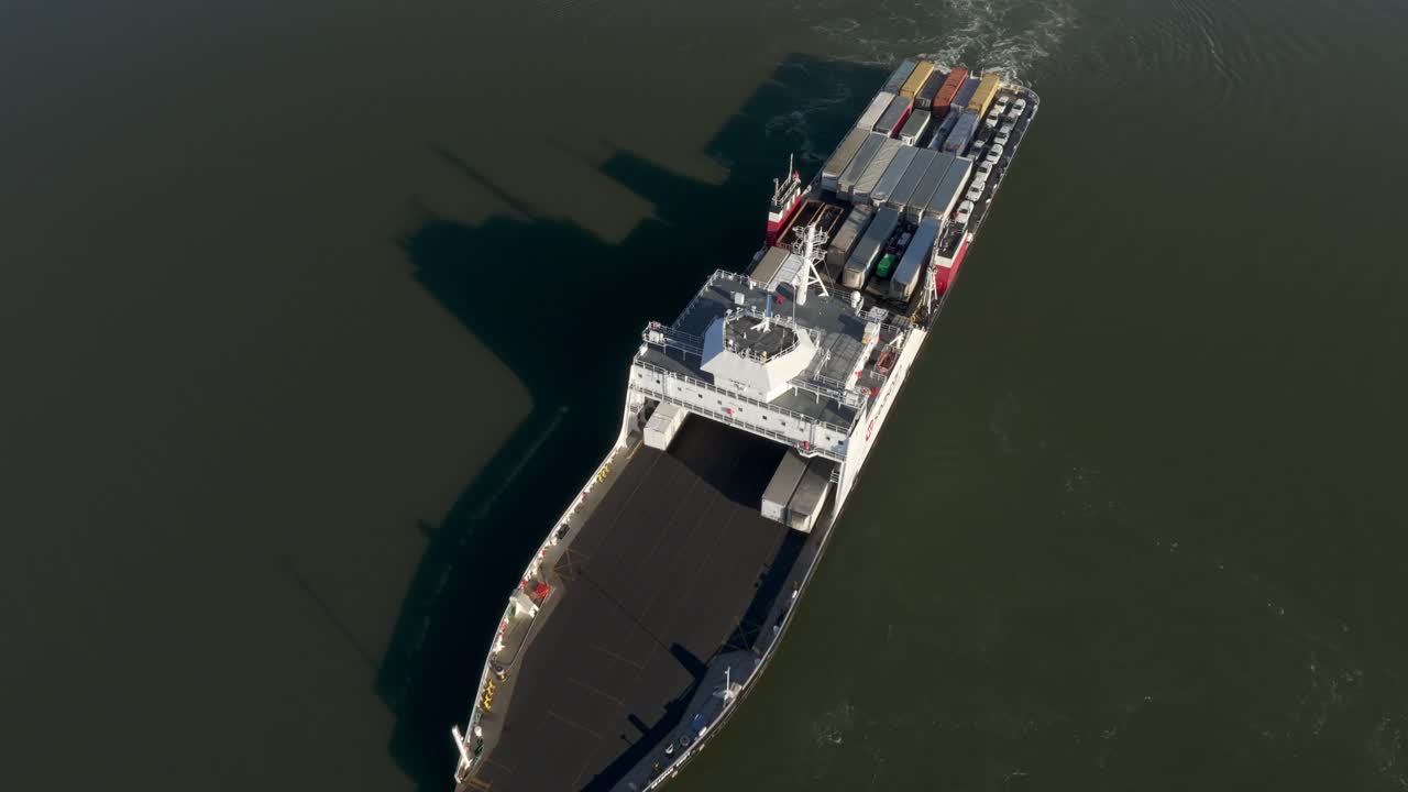 Ro-Ro Cargo Ship Navigating Across Fraser River In British Columbia, Canada. aerial tilt-down shot