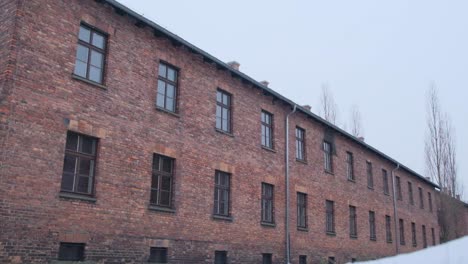 aerial shot of brick building in snowy landscape cold sky enhances solitude a cinematic shot of a large brick building with many windows in a snowy landscape the overcast sky enhances the atmosphere of solitude and mystery making it a visually impressive scene
