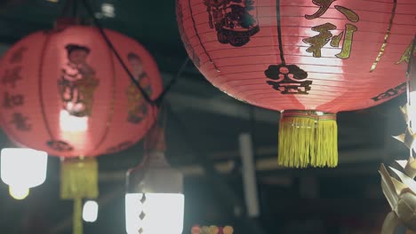 tassels on chinese lantern in street cafe in evening