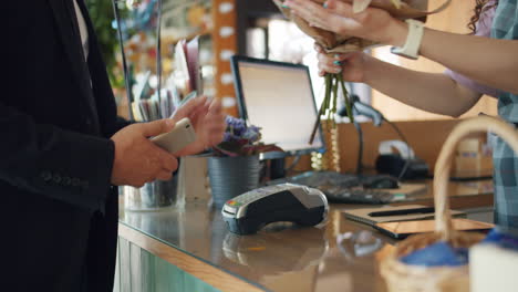 customer paying for flowers at a florist shop