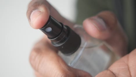 Hand spraying a bottle