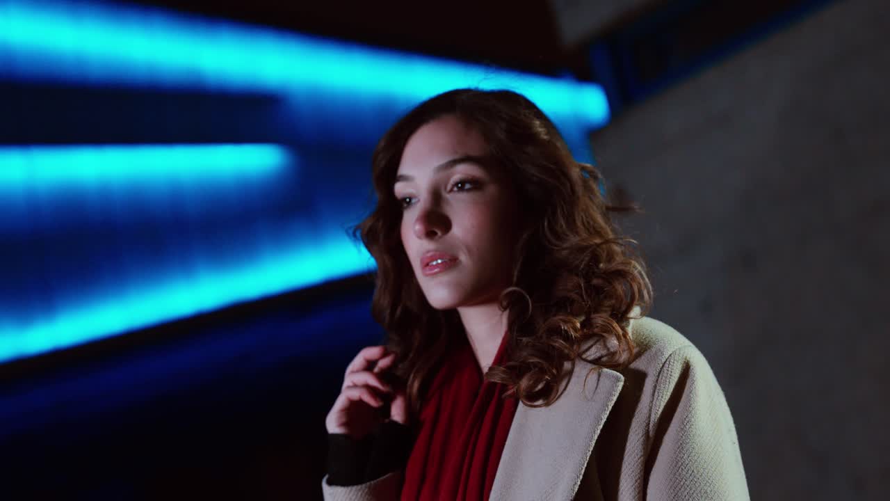 Thoughtful Young Woman in Blue Neon Light, Night City Portrait, Copy Space