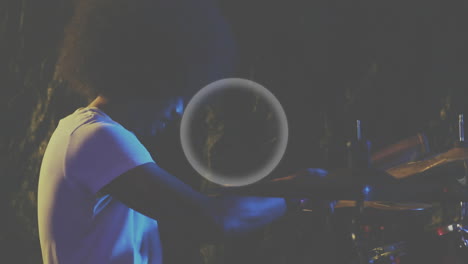 male drummer playing drum kit on dark stage, featuring animated sound waves and music industry data