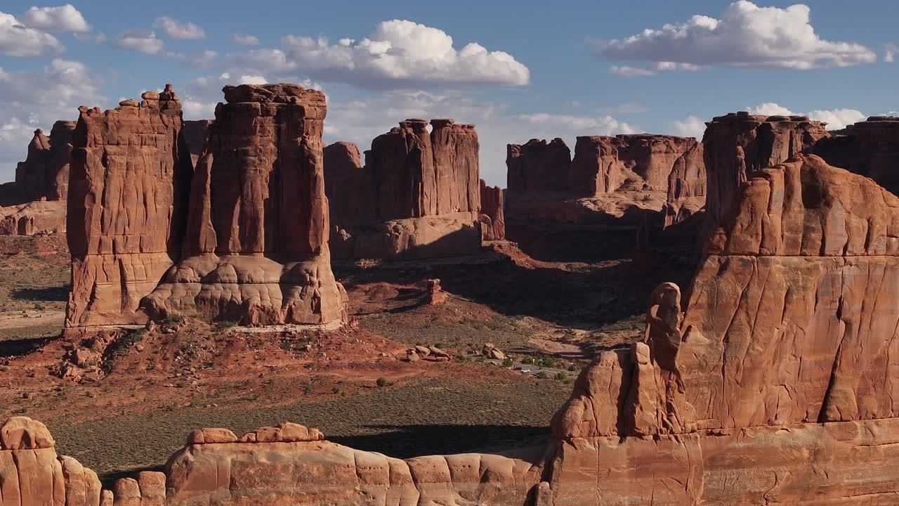 Majestic red rock formations stand tall in the dramatic desert landscape of Moab, Utah USA - aerial