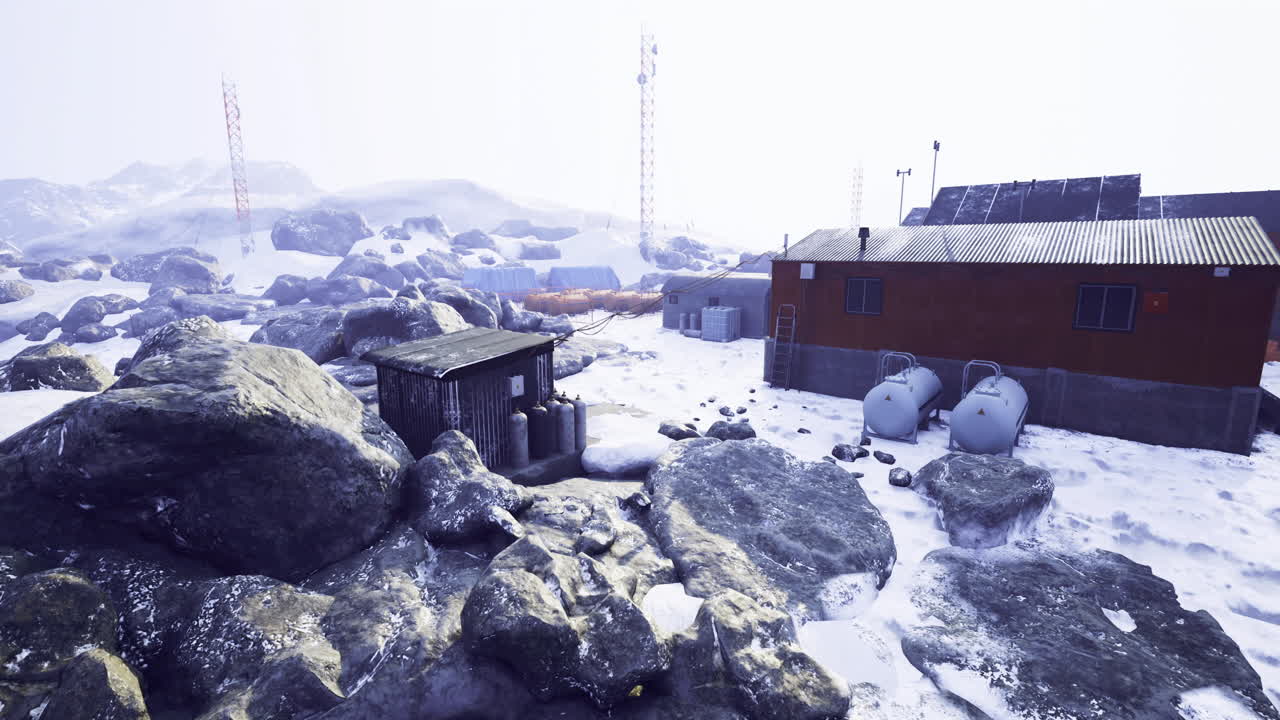 Remote research station nestled among rugged rocky terrain in snowy conditions