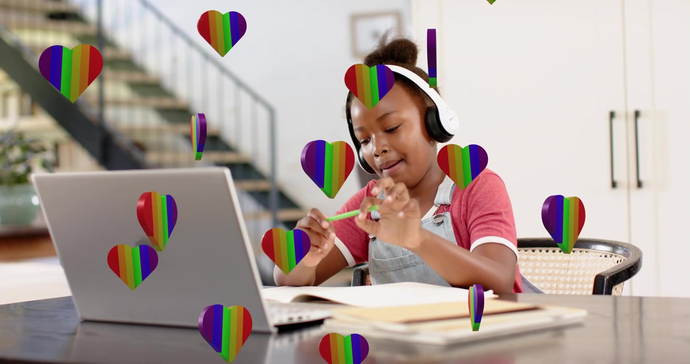 rainbow heart overlays floating initiating schoolgirl tapping pencil, writing notes in online study