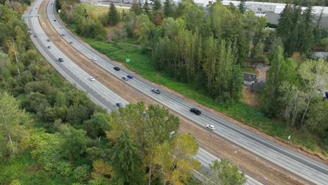 Aerial-view-of-cars-quickly-zipping-down-the-freeway