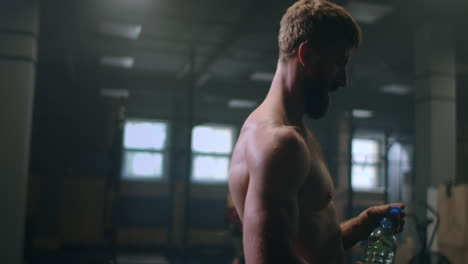 a tired man in the gym is resting after performing an exercise. take a break after training.