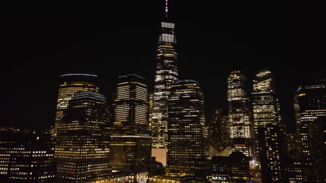 aerial view of the illuminated north cove marina in lower manhattan, quiet night in new york - descending, drone shot
