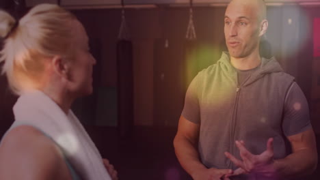 talking in gym, two people with towels over colorful light animation