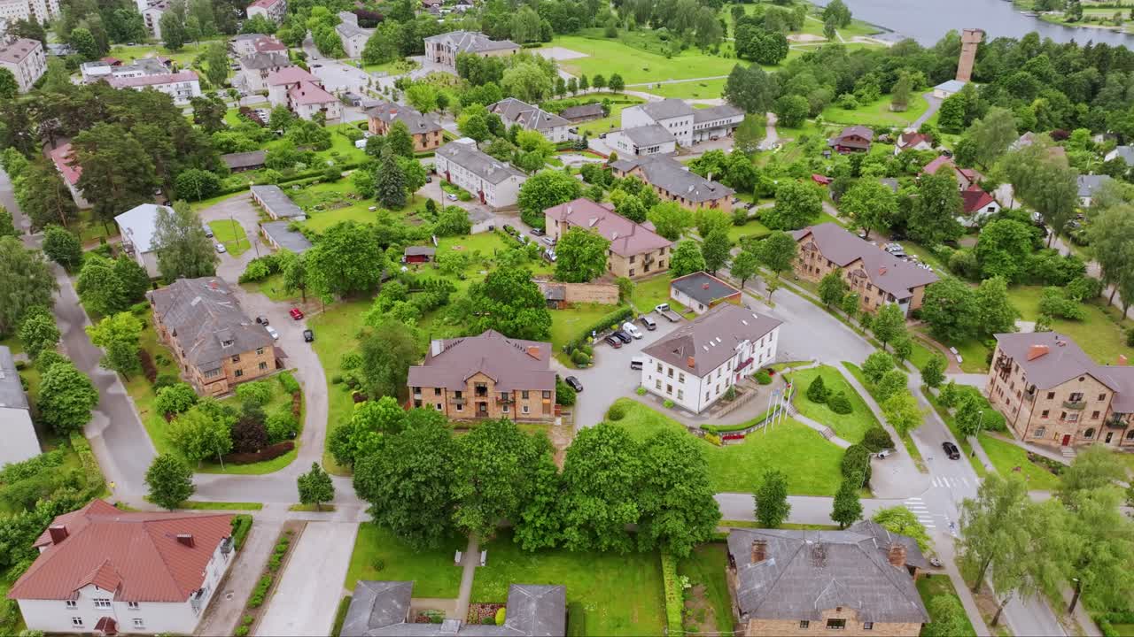 Drone flying forward over Broceni Latvia revealing quiet town near lake