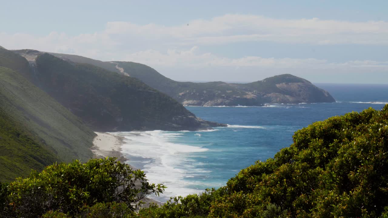A stunning long shot of Bald Head Peninsula, showcasing its rugged coastline, surrounding waters, and dramatic cliffs.