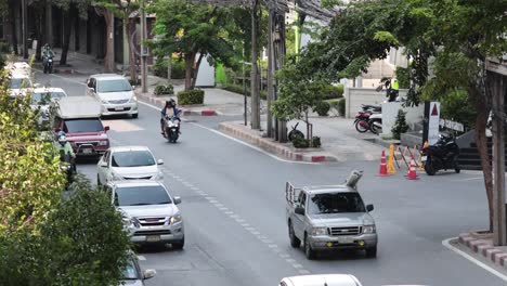 vehicles and motorcycles on a busy street