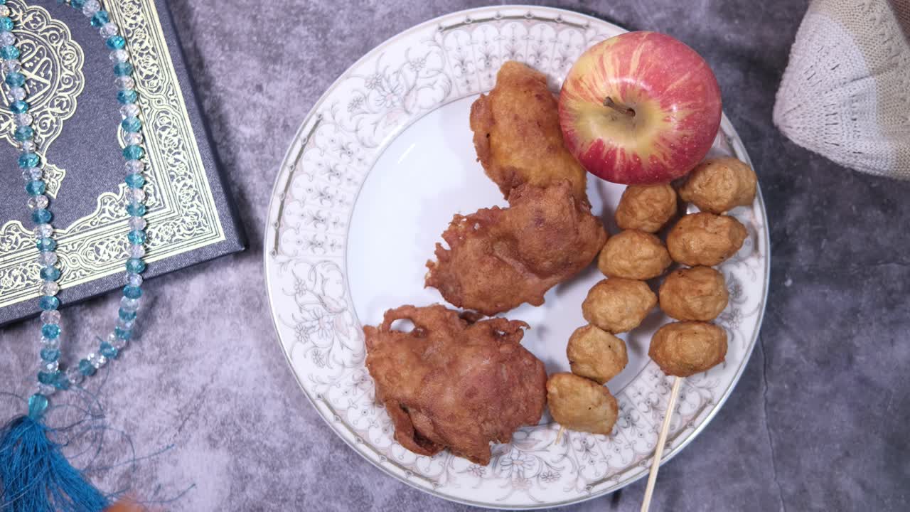 Fried Chicken, Meatballs, and Apple with Quran and Prayer Beads
