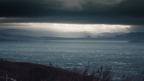 A-timelapse-of-sun-rays-pierce-the-thick-gray-cloud-cover-above-the-fjord