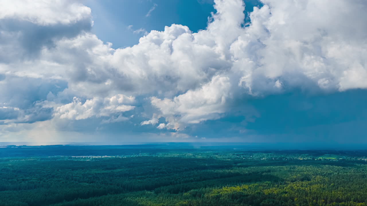 Rainstorm cloud drifting over forest canopy in drone hyperlapse