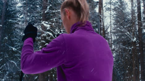 Young-adult-Caucasian-female-athlete-practicing-cross-country-skiing-on-a-scenic-forest-trail.-4K-UHD-60-FPS-SLO-MO