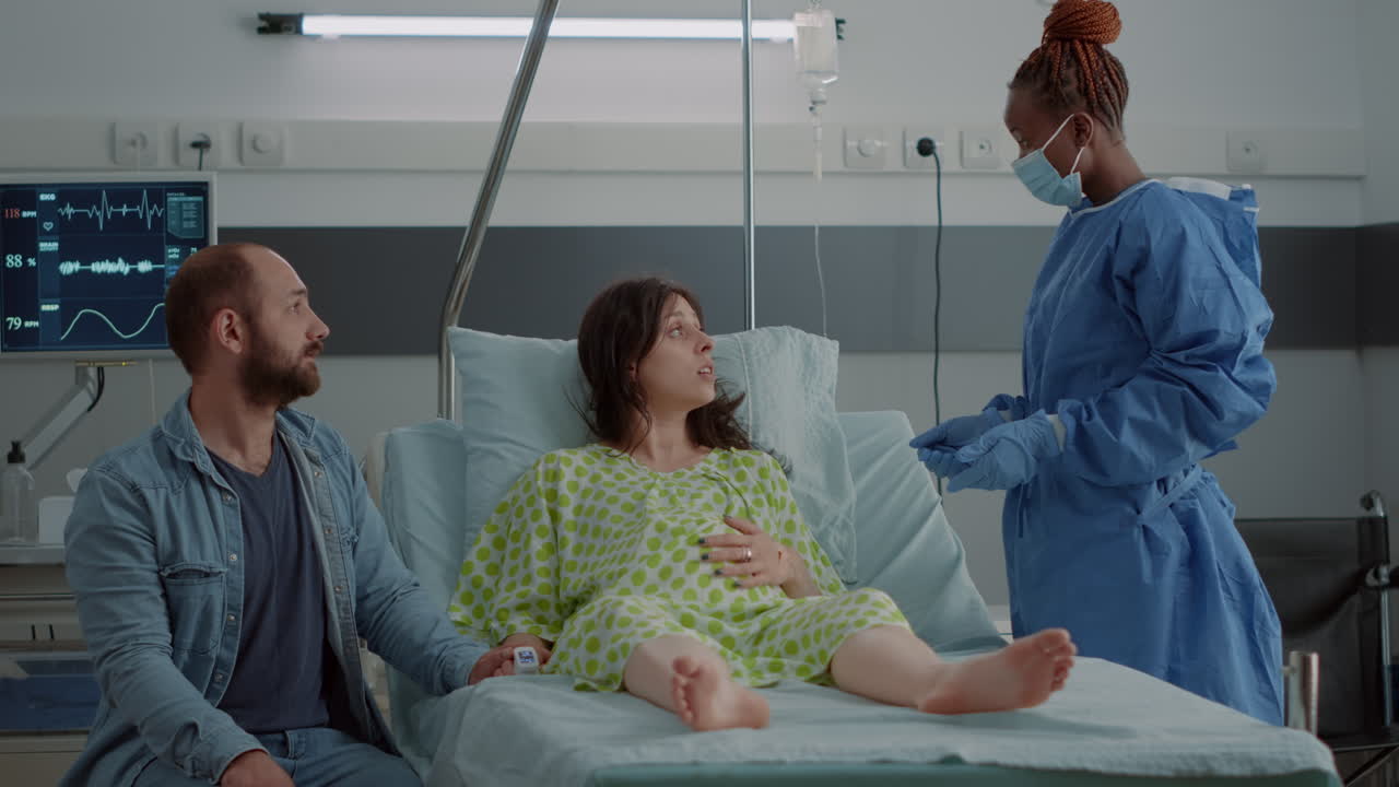 Woman expecting child sitting in hospital ward