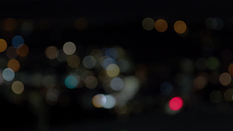 Nighttime-cityscape-in-Wellington,-focus-pull-and-Bokeh-lighting-pan-left