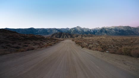 gravel road leading to rugged mountains, alabama hills, lone pine