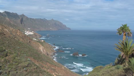 Relajante-Vista-De-La-Línea-Costera-Con-Montañas-Altas,-Cielo-Azul,-Nubes-Blancas-Esponjosas-Y-Olas-Rompiendo,-Tenerife,-España