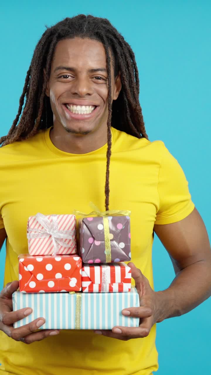 Man Holding Stack of Gifts