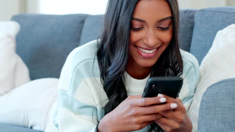 Young-woman-texting-on-her-phone-while-relaxing