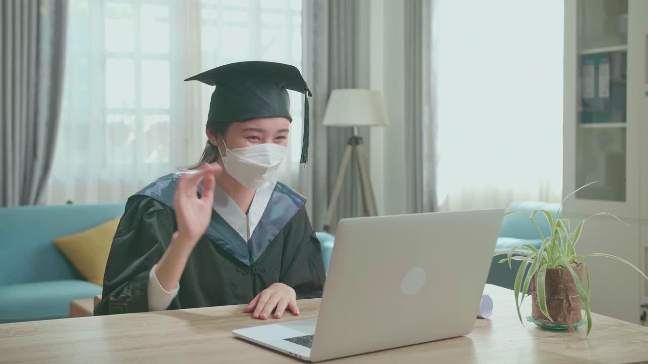 Asian Woman Wearing Protection Face Mask Having Video Call In Living Room