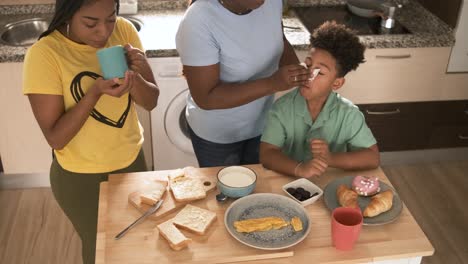 family shares a morning meal together in the kitchen