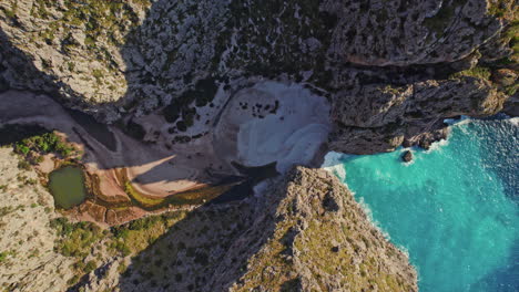 sa calobra beach between the canyon of torrent de pareis in mallorca, spain