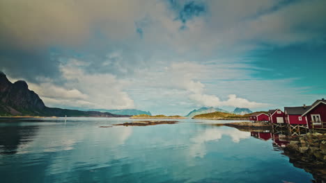 Picturesque nordic landscape. Lofoten islands, Norway.
Dramatic cloudy sky reflecting on the sea. View of the red fishermen cabins.