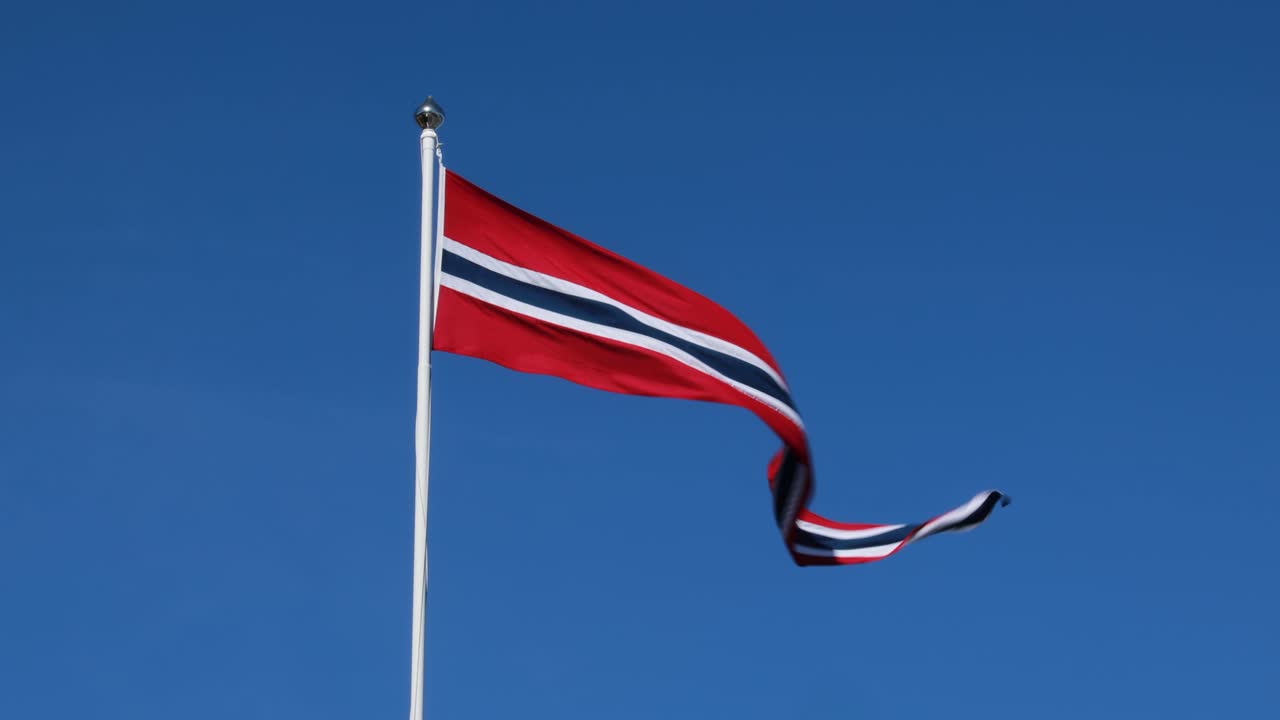 노르웨이  ⁇ 발이 깊은 파란 하늘을 배경으로 바람에 흔들리고 있습니다.