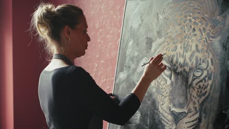 woman painting a leopard portrait