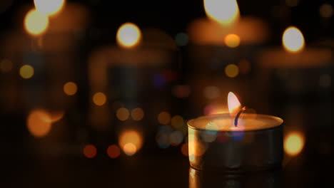 animation of lit candles over out of focus city lights