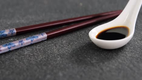Chopsticks-and-soy-sauce-on-black-stone-slate