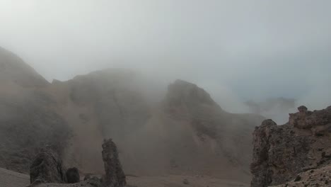 fog lifting up and revealing the amazing dolomite mountains.  handhold camera movement.