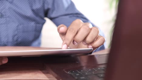 person using tablet and laptop