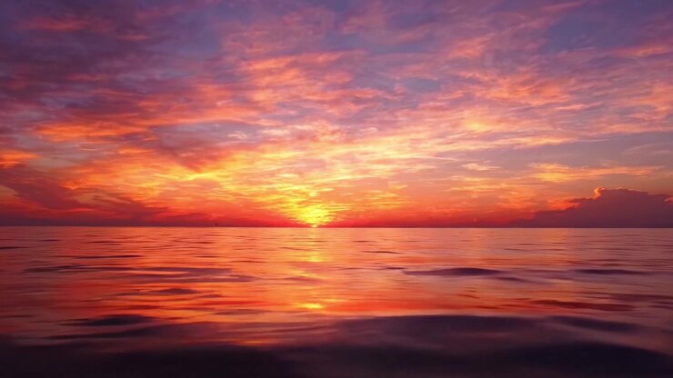 A Breathtaking Sunset Over Calm Waters, Showcasing Vibrant Colors and Serene Reflections That Capture the Tranquility of Nature's Evening Splendor