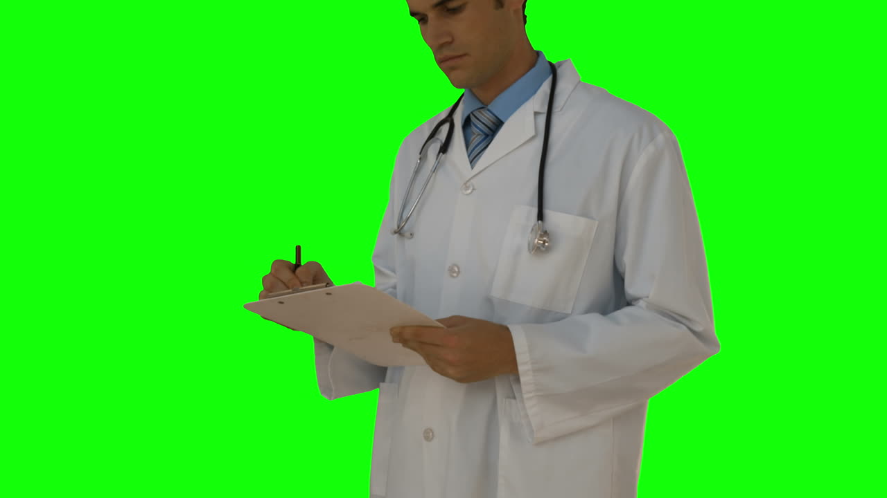 Young doctor writing on clipboard