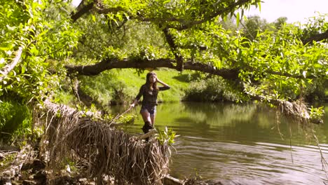 young woman with a dog walking through the river