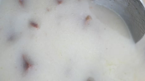 close-up of a creamy soup with meat