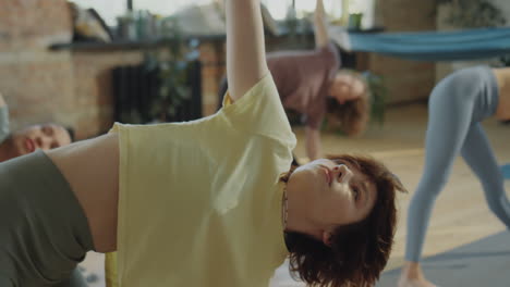 women practicing yoga in a group class